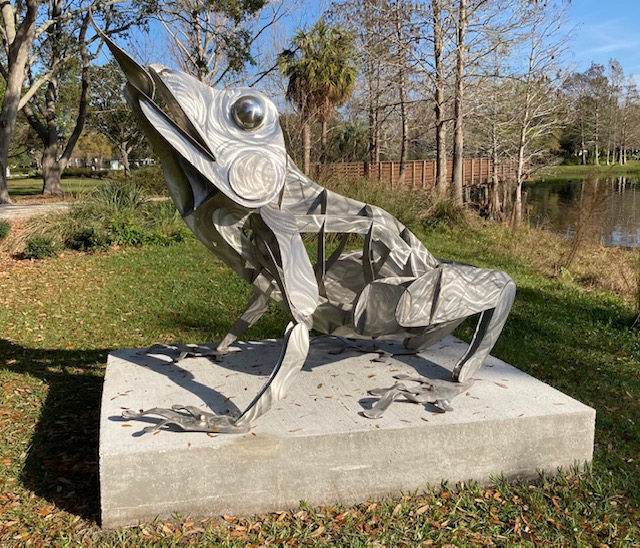 Metal frog sculpture in park